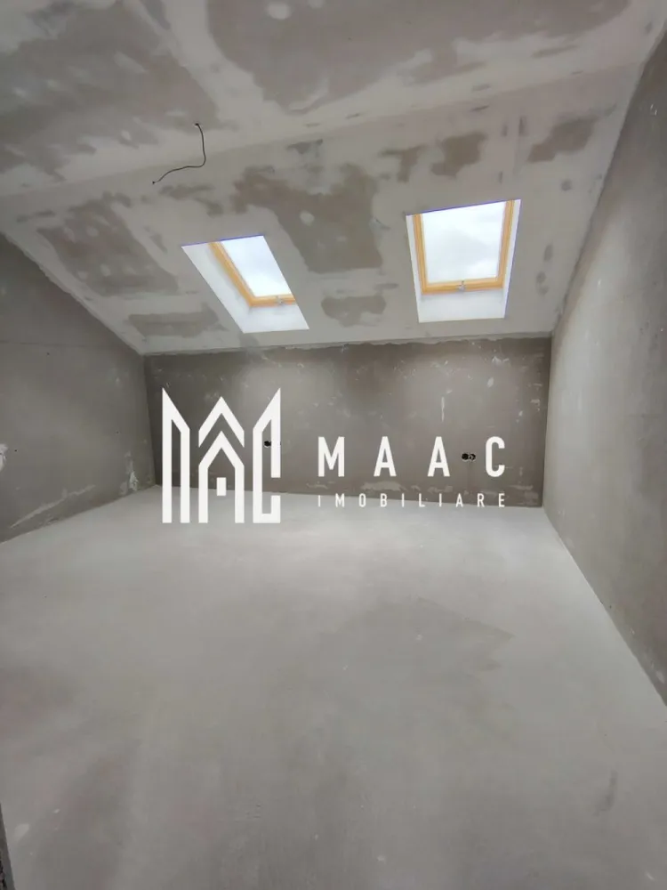 Casa Rezidentiala |5 Camere | Parcare |Sura Mica - MACC IMOBILIARE vă oferă spre vânzare 
Casa C2 este o locuință cuplată tip P+M, ideală pentru o familie care caută echilibru între spațiu, confort și intimitate.

- Teren total: 328,93 mp
- Amprentă la sol: 113,08 mp
- Teren liber: ~119,5 mp
- 2 locuri de parcare pavate în curte (față)
-Zonă BBQ pavata în curtea din spate
- Acces pe drum privat propriu
- Front stradal: 9,8 m

 Compartimentare interioară – 156,29 mp utili:

Parter:

Hol – 14,89 mp
Cameră de zi – 39,85 mp
Bucătărie – 10,57 mp (open-space cu livingul)
Cameră – 16,5 mp
Baie – 6,71 mp
Scară interioară de acces mansardă

Mansardă:

Hol – 17,26 mp
Baie – 5,08 mp
Birou – 10,17 mp
Dormitor 1 – 17,14 mp
Dormitor 2 – 18,12 mp

 Înălțime utilă etaj: de la 1,69 m la 3,10 m

 Caracteristici și dotări – Casa C2, construcție nouă 2025, semifinisată:

Centrală termică pe gaz Ferroli

Încălzire în pardoseală Viega la parter

Radiatoare de aluminiu la mansardă

Instalații electrice complete (curenți tari și slabi, tablou electric trifazic)

Instalație sanitară completă (fără obiecte sanitare)

Infrastructură pentru termostate

 Ușă metalică la intrare
Tâmplărie termoizolantă Salamander (7 camere), geamuri mari, triplu vitraj (3 foi sticlă, garnituri izolante, Low-E), feronerie Roto

- Pereți tencuiți, șapă mecanizată
- Fațade cu tencuială decorativă
- Acoperiș din țiglă ceramică
- Scări din beton
- Terasă acoperită și pavata

 Contoare individuale montate la limita proprietății (apă, gaz, electricitate)
-Rețea electrică nouă + post de transformare propriu
-Împrejmuire individuală – intimitate față de vecini

 Avantaje cheie:
- Compartimentare modernă și funcțională
- Lumină naturală din abundență
- Intimitate și confort optim pentru o familie
- Acces rapid spre orașul Sibiu

 Finalizare în 2025 – livrare semifinisată, pregătită pentru personalizarea finisajelor