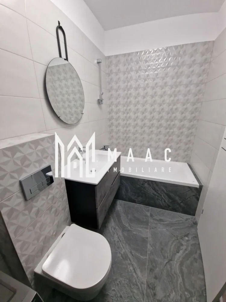 Apartament 2 camere I lift I Doamna Stanca - MAAC Imobiliare vă propune spre închiriere un apartament cu 2 camere, situat la etajul 6 din 7 al unui imobil nou amplasat pe strada Doamna Stanca, într-o zonă modernă și foarte bine conectată la principalele puncte de interes din Sibiu. Proprietatea este ideală pentru persoanele care își doresc confort, acces rapid către zone comerciale și o locuință complet mobilată și utilată, disponibilă imediat.

Apartamentul beneficiază de compartimentare decomandată, oferind un spațiu eficient organizat și luminos. Locuința este compusă din hol de acces, living open-space cu bucătărie, dormitor, baie cu cadă și un balcon generos, cu acces atât din living, cât și din dormitor, perfect pentru relaxare și pentru un plus de confort.

Imobilul este amplasat într-o zonă cu acces facil către numeroase supermarketuri și Shopping City Sibiu, oferind toate avantajele unei locații moderne și dinamice, potrivite pentru un stil de viață activ.

Apartamentul se predă complet mobilat și utilat, fiind pregătit pentru mutare imediată. Se percepe o garanție în cuantumul unei chirii lunare. Proprietatea nu acceptă animale de companie.

Caracteristici:
-Apartament cu 2 camere
-Etaj 6 din 7
-Imobil nou
-Compartimentare decomandată
-Living open-space cu bucătărie
-Balcon generos cu acces din living și dormitor
-Baie cu cadă
-Se predă mobilat și utilat
-Disponibil imediat
-Aproape de supermarketuri și Shopping City Sibiu
-Zonă cu acces facil către punctele de interes
-Nu se acceptă animale de companie

Pentru mai multe detalii, vă rugăm să menționați telefonic numărul CP3062631.