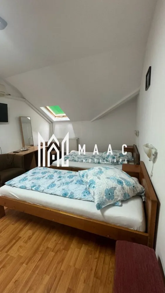 Pensiune la cheie | 229mpu/ nivel | 7 minute de centru sibiului - MAAC Imobiliare va oferă spre vanzare o pensiune complet utilata.
Localizare: Sibiu

Caracteristici și Dotări:
Camere: 13 camere, fiecare cu baie proprie

Spații comune:
Bucătărie complet echipată
Recepție/Bar pentru primirea oaspeților
Terasă spațioasă pentru relaxare
Birou/Oficiu: Spațiu dedicat pentru activitățile administrative

Avantaje și Facilități:
Confort: Fiecare cameră este dotată cu toate necesitățile pentru a oferi un sejur plăcut oaspeților
Utilități: Pensiunea este echipată cu toate utilitățile necesare pentru funcționare, inclusiv 2 centrale proprii
Siguranță: Scară de incendiu și autorizație ISU
Design: Interior modern și funcțional, potrivit pentru o experiență turistică de calitate

Oportunitate de Investiție:
Profitabilitate: Ideală pentru investiție în domeniul turismului, având potențial ridicat datorită numărului mare de camere și facilităților oferite
Localizare: Situată într-o zonă atractivă din Sibiu, care atrage turiști pe tot parcursul anului

Pentru mai multe informații sau pentru a programa o vizionare, nu ezitați să ne contactați, specificand ID: CP2083185