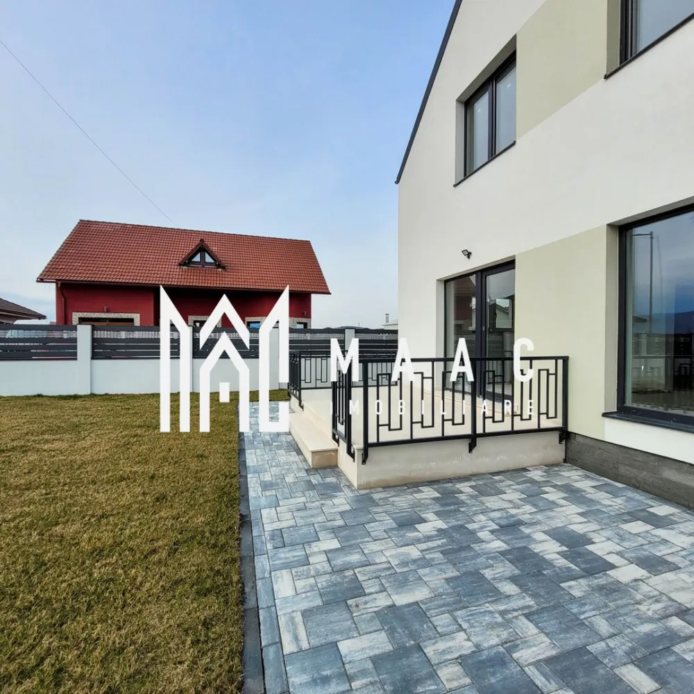 Casa Individuala | 120MPU | Cristian | Curte 420MPU - MAAC Imobiliare vă propune spre vânzare o casă individuală situată în localitatea Cristian, o proprietate modernă care se predă la stadiul „la cheie”, atât la interior, cât și la exterior, fiind pregătită pentru mutare imediată. În prezent, imobilul este complet finisat, cu băile amenajate, parchet montat și uși interioare instalate.

Imobilul este construit cu atenție la detalii și beneficiază de materiale de calitate, fiind izolat cu vată bazaltică de 10 cm și finisat la exterior cu vopsea decorativă albă. Tâmplăria este realizată din termopan Salamander cu 7 camere și geam tripan, asigurând un nivel ridicat de izolare termică și fonică.

Proprietatea este racordată la toate utilitățile necesare unei locuințe moderne:

apă
canalizare
gaze naturale
cablu TV
internet

Curtea este complet amenajată și împrejmuită cu gard din zidărie și elemente orizontale din aluminiu antracit, oferind intimitate și un aspect modern. Spațiul exterior este pavat cu dale de la ELIS, iar zona verde este amenajată cu gazon și sistem automat de irigare.

Caracteristicile imobilului sunt următoarele:

amprentă la sol: 72 mp
terasă: 22 mp
suprafață construită: 144 mp
suprafață utilă: 118 mp
suprafață teren: 420 mp

Această proprietate reprezintă o opțiune potrivită pentru cei care își doresc o casă nouă într-o zonă liniștită, aproape de Sibiu, cu spațiu exterior generos și dotări moderne.

Pentru mai multe detalii, vă rugăm să menționați telefonic că ați văzut anunțul cu CP1972296.