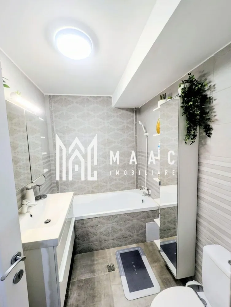 Apartament 2 camere | Mobilat | Arhitecților - MAAC Imobiliare vă oferă spre vânzare, un apartament deosebit cu 2 camere și pod amenajat, situat în prima parte a Cartierului Arhitecților, pe strada Irina Rosetti, cu acces rapid către Sibiu.

Locuința dispune de 51 mp utili, la care se adaugă un pod amenajat de aproximativ 25 mp, ideal pentru birou, dormitor suplimentar sau spațiu multifuncțional.

Compartimentare:
living luminos;
dormitor;
bucătărie închisă;
baie;
balcon închis, izolat și încălzit, utilizat ca spațiu tehnic și de depozitare;
pod amenajat.

Apartamentul a fost amenajat pentru uz personal, folosindu-se materiale și finisaje de calitate, oferind un nivel ridicat de confort.

Dotări:
centrală termică proprie;
aer condiționat pe ambele niveluri;
iluminat inteligent controlabil prin telefon;
scară interioară din metal tratat și lemn de fag.

Se vinde complet mobilat și utilat, inclusiv cu electrocasnice Electrolux, Bosch și televizor Sony, fiind pregătit pentru mutare imediată.
O alegere excelentă atât pentru locuință proprie, cât și pentru investiție, într-una dintre cele mai apreciate zone rezidențiale din apropierea Sibiului.

Pentru detalii suplimentare și programarea unei vizionări, vă rugăm să menționați numărul de referință CP3089402.