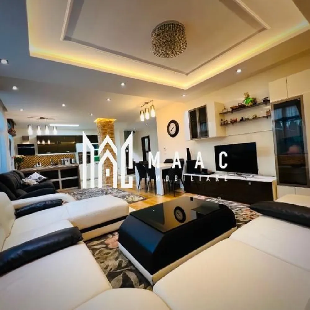 Casă 4 camere | 135mp utili + terasă 55 mp | Curte 180mp - MAAC Imobiliare vă propune spre vânzare o casă modernă și elegantă, situată în Șelimbăr, într-o zonă liniștită, cu acces rapid către Shopping City Sibiu, parcuri și zone de recreere, grădinițe, școli și transport în comun, ideală pentru o familie care își dorește confort și funcționalitate într-un cadru rezidențial bine cotat.

Proprietatea are o suprafață utilă de 134,5 mp, terasă panoramică de 55 mp la etaj retras, teren de 249,5 mp și o curte liberă de aproximativ 180 mp.

Compartimentare:

Parter:
-living generos, cu aer elegant
-bucătărie open-space
-bucătărie închisă, complet utilată
-baie de serviciu
-acces direct către curte

Etaj:
-3 dormitoare spațioase, mobilate modern
-baie mare cu jacuzzi

Etaj retras:
-baie cu duș
-spațiu pentru mașină de spălat rufe
-terasă panoramică de 55 mp

Dotări și finisaje:
-mobilier premium la comandă
-canapele Mobexpert și Divani & Sofa
-tavane cu spoturi și iluminat LED ambiental
-marmură la parter, în hol, bucătării și baie de serviciu
-lemn natural în living
-scară din lemn masiv cu balustradă din fier forjat decorativ
-tâmplărie QFORT tripan
-centrală termică Viessmann
-instalații electrice Schneider

Exterior și facilități:
-curte amenajată cu gazon, plante decorative și gard viu din tuia
-sistem automat de irigații pentru gazon și flori
-poartă de acces și poartă de garaj automatizate cu telecomandă
-două locuri de parcare în curte
-căsuță de grădină pentru depozitare

Locuința se predă complet mobilată și utilată, în stare excelentă, reprezentând o opțiune potrivită pentru cei care caută o casă modernă în Șelimbăr, aproape de facilitățile urbane din Sibiu.

Pentru mai multe detalii sau programarea unei vizionări vă rugăm să menționați la telefon numărul CP2676807.