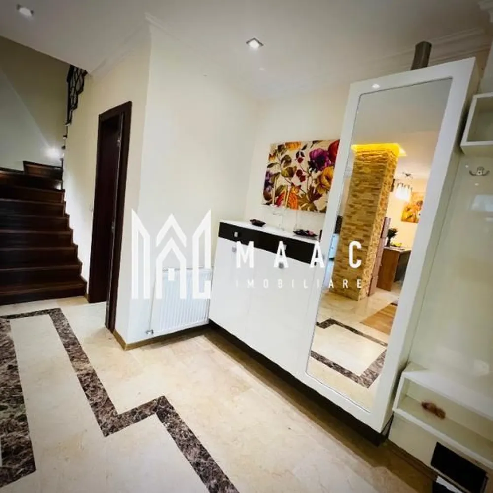 Casă 4 camere | 135mp utili + terasă 55 mp | Curte 180mp - MAAC Imobiliare vă propune spre vânzare o casă modernă și elegantă, situată în Șelimbăr, într-o zonă liniștită, cu acces rapid către Shopping City Sibiu, parcuri și zone de recreere, grădinițe, școli și transport în comun, ideală pentru o familie care își dorește confort și funcționalitate într-un cadru rezidențial bine cotat.

Proprietatea are o suprafață utilă de 134,5 mp, terasă panoramică de 55 mp la etaj retras, teren de 249,5 mp și o curte liberă de aproximativ 180 mp.

Compartimentare:

Parter:
-living generos, cu aer elegant
-bucătărie open-space
-bucătărie închisă, complet utilată
-baie de serviciu
-acces direct către curte

Etaj:
-3 dormitoare spațioase, mobilate modern
-baie mare cu jacuzzi

Etaj retras:
-baie cu duș
-spațiu pentru mașină de spălat rufe
-terasă panoramică de 55 mp

Dotări și finisaje:
-mobilier premium la comandă
-canapele Mobexpert și Divani & Sofa
-tavane cu spoturi și iluminat LED ambiental
-marmură la parter, în hol, bucătării și baie de serviciu
-lemn natural în living
-scară din lemn masiv cu balustradă din fier forjat decorativ
-tâmplărie QFORT tripan
-centrală termică Viessmann
-instalații electrice Schneider

Exterior și facilități:
-curte amenajată cu gazon, plante decorative și gard viu din tuia
-sistem automat de irigații pentru gazon și flori
-poartă de acces și poartă de garaj automatizate cu telecomandă
-două locuri de parcare în curte
-căsuță de grădină pentru depozitare

Locuința se predă complet mobilată și utilată, în stare excelentă, reprezentând o opțiune potrivită pentru cei care caută o casă modernă în Șelimbăr, aproape de facilitățile urbane din Sibiu.

Pentru mai multe detalii sau programarea unei vizionări vă rugăm să menționați la telefon numărul CP2676807.