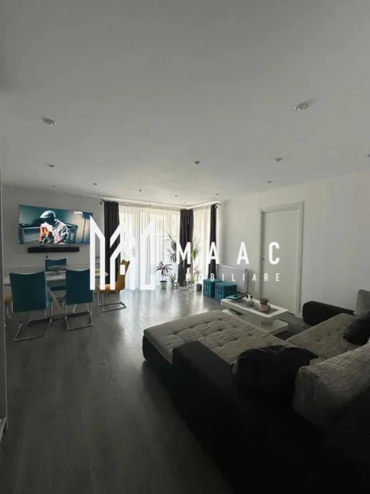 Apartament 3 camere | Mobilat | Gradina | Parcare | Selimbar - MAAC Imobiliare vă prezintă spre vânzare un apartament de 3 camere cu gradina, situat în Șelimbăr, într-o zonă rezidențială apreciată.

Caracteristici:
Apartament amplasat într-un imobil construit în anul 2016.
Un singur apartament pe nivel.
Bloc cu doar 4 apartamente.
Parter înalt, la aproximativ 1 metru de sol.

Suprafețe și spații exterioare:
Suprafață utilă de 83 mp.
Terasă cu suprafața de 17 mp.
Grădină privată de 33 mp, cu acces direct.
Două locuri de parcare înscrise în acte, cu suprafața totală de 25 mp.
Posibilitate de parcare pentru o a treia mașină în spatele locurilor existente.
Locuri de parcare suplimentare pentru vizitatori.

Compartimentare:
Living generos și primitor, cu spațiu de cămară.
Bucătărie complet mobilată și utilată.
Două dormitoare complet mobilate, fiecare cu suprafața de aproximativ 14 mp.
Dressinguri realizate la comandă, inclusiv un dressing de mari dimensiuni, de aproximativ 4 m x 2,5 m.
Baie complet echipată.

Orientare și acces:
Orientare sud pentru living, bucătărie și terasă, oferind lumină naturală pe tot parcursul zilei.
Orientare nord pentru dormitoare și zona de parcare.
Trei accesuri către terasă, din living, bucătărie și grădină.
Acces în grădină și din zona de parcare.

Construcție și izolații:
Uși interioare Porta Doors.
Ferestre cu trei foi de sticla.
Placă între etaje de 20 cm.
Ziduri interioare de 20 cm și ziduri exterioare de 30 cm.

Dotări și electrocasnice:
Electrocasnice Bosch, inclusiv mașină de spălat vase, cuptor și plită.
Frigider Liebherr.
Televizor Sony Bravia cu diagonală de 165 cm.
Mașină de spălat rufe și uscător încorporate.

Predare:
Apartamentul se vinde complet mobilat și utilat, fiind pregătit pentru mutare imediată, fără necesitatea unor investiții suplimentare.

Pentru mai multe detalii precizati telefonic ca ati vazut anuntul cu ID: CP2876942