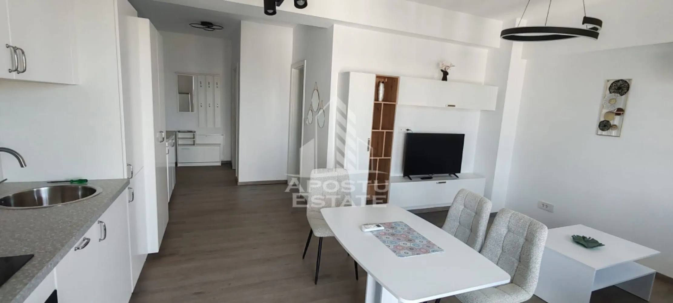 Apartament modern 2 camere de inchiriat, Timisoara zona Lipovei - APOSTU ESTATE va ofera spre inchiriere un apartament cu 2 camere decomandat, situat la etajul 5/6 al unui bloc cu lift, in zona Lipovei.

Vecinatati si puncte de interes:
- supermarketuri – Lidl si Kaufland, foarte accesibile,
- statii de transport in comun – pentru acces rapid catre alte zone ale orasului,
- diverse farmacii, banci si alte facilitati urbane esentiale;

Imobilul se intinde pe o suprafata utila de 47 mp, plus un balcon deschis si este compartimentat astfel:
- hol de acces;
- dormitor cu iesire pe balcon;
- baie;
- bucatarie open-space cu livingul;
- living cu iesire pe terasa.

Confortul termic este asigurat prin intermediul centralei termice pe gaz (incalzire in pardoseala) si al aparatului de aer conditionat.

Apartamentul dispune de:
- masina de spalat vase;
- videointerfon;
- loc de parcare subteran cu bariera.

Pretul de inchiriere al apartamentului este de 450 euro pe luna plus garantia pentru o luna.

Va asteptam cu drag la o vizionare!
