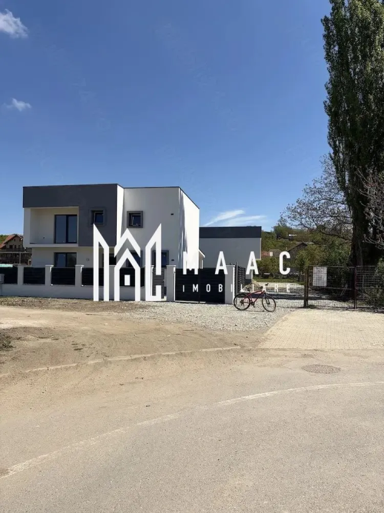 Casă individuală 4 camere | Bungard | 186 mp utili, teren 350 mp - Casă individuală cu 4 camere de vânzare în Bungard, cu 186 mp utili, teren de 350 mp și acces facil către Sibiu. Proprietatea este semifinisată, construită în 2026, și oferă spațiu interior generos, curte proprie și terasă acoperită.

Detalii proprietate:
• Suprafață utilă: 186 mp
• Teren: 350 mp
• Regim de înălțime: P+1
• 4 camere și 3 băi
• Stadiu interior: semifinisat
• Balcon și terasă acoperită de 40 mp
• Încălzire în pardoseală la parter și la etaj
• Centrală termică pe gaz
• Tâmplărie PVC Salamander cu 3 foi de sticlă
• Izolație exterioară cu polistiren de 15 cm
• Construcție din cărămidă
• 2 locuri de parcare
• Utilități disponibile: apă curentă, canalizare, energie electrică, gaz, internet și cablu TV

Locație și acces:
Proprietatea este situată în Bungard, la aproximativ 15 minute de centrul Sibiului. Accesul se face direct din drum asfaltat, iar exteriorul include curte amenajată cu dale și spațiu verde.

Cod anunț CP3089203. Contactați-ne pentru o vizionare și pentru informații suplimentare.