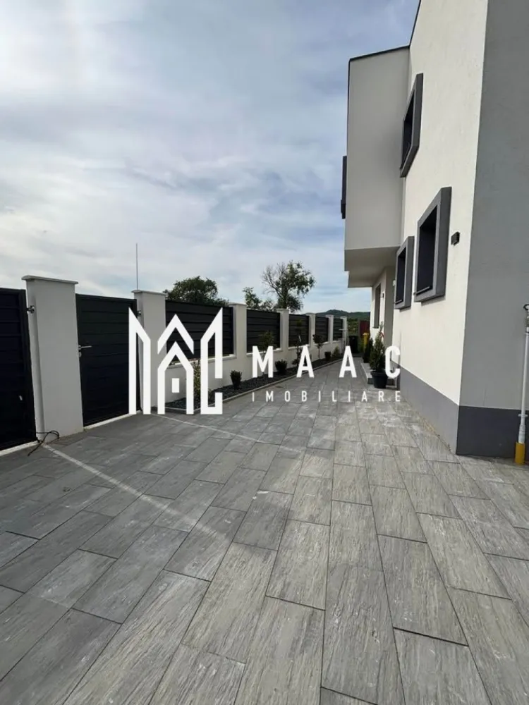 Casă individuală 4 camere | Bungard | 186 mp utili, teren 350 mp - Casă individuală cu 4 camere de vânzare în Bungard, cu 186 mp utili, teren de 350 mp și acces facil către Sibiu. Proprietatea este semifinisată, construită în 2026, și oferă spațiu interior generos, curte proprie și terasă acoperită.

Detalii proprietate:
• Suprafață utilă: 186 mp
• Teren: 350 mp
• Regim de înălțime: P+1
• 4 camere și 3 băi
• Stadiu interior: semifinisat
• Balcon și terasă acoperită de 40 mp
• Încălzire în pardoseală la parter și la etaj
• Centrală termică pe gaz
• Tâmplărie PVC Salamander cu 3 foi de sticlă
• Izolație exterioară cu polistiren de 15 cm
• Construcție din cărămidă
• 2 locuri de parcare
• Utilități disponibile: apă curentă, canalizare, energie electrică, gaz, internet și cablu TV

Locație și acces:
Proprietatea este situată în Bungard, la aproximativ 15 minute de centrul Sibiului. Accesul se face direct din drum asfaltat, iar exteriorul include curte amenajată cu dale și spațiu verde.

Cod anunț CP3089203. Contactați-ne pentru o vizionare și pentru informații suplimentare.