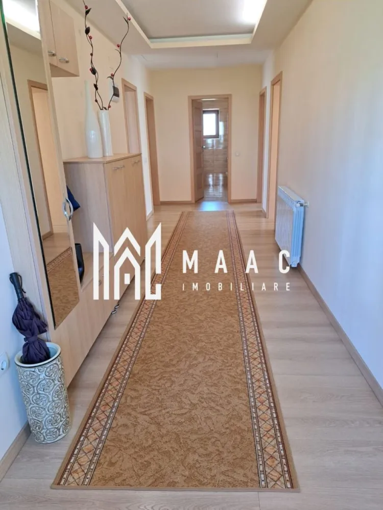Casă individuală | 184 MPU | Teren 500MP | Șura Mare - MAAC Imobiliare vă propune spre vânzare o casă individuală modernă, cu 5 camere, situată în Șura Mare, la doar câteva minute de Sibiu, într-o zonă liniștită, ideală pentru familie.

Proprietatea dispune de o suprafață utilă de 184 mp și este amplasată pe un teren generos de 500 mp, oferind spațiu, confort și intimitate.

Compartimentare:
Demisol:
Garaj spațios
Cameră multifuncțională
Camera centralei
Pivniță
Baie de serviciu

Parter:
Living luminos
3 dormitoare
Bucătărie separată
Hol
Baie

Locuința beneficiază de sistem de încălzire pe gaz sau pe peleți, oferind flexibilitate și eficiență energetică.

Exteriorul este amenajat cu zonă verde, pomi fructiferi și curte pavată, ideală pentru relaxare sau petrecerea timpului în aer liber. Strada este în curs de asfaltare, cu termen estimat de finalizare în 2–3 luni, ceea ce va aduce un plus de confort și valoare proprietății.

Casa se vinde complet mobilată și utilată și poate fi predată imediat.

Pentru mai multe detalii sau pentru programarea unei vizionări, vă rugăm să ne contactați.
Specificați ID-ul CP2926583.