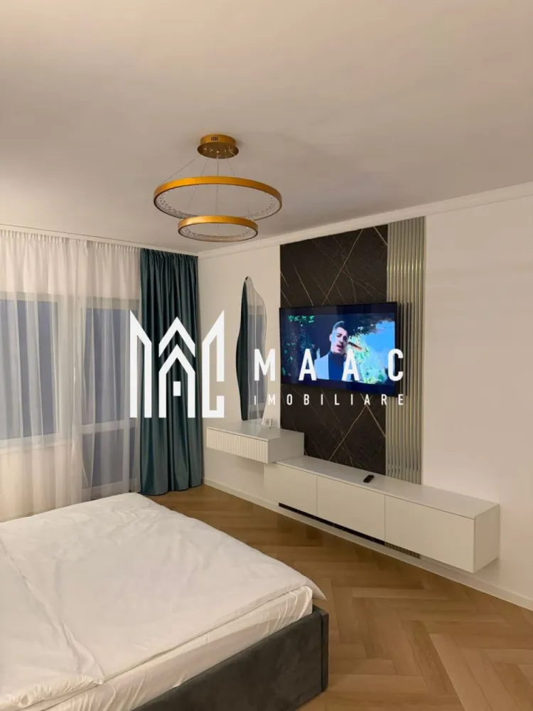 Apartament 3 camere decomandat | Sibiu Hipodrom 4 | 60 mp, parcare - Apartament cu 3 camere decomandat de închiriat în Sibiu, pe Strada Doamna Stanca, în zona Hipodrom 4, cu 60 mp utili, balcon și loc de parcare privat.

Detalii proprietate:
• Suprafață utilă: 60 mp, suprafață construită: 78 mp
• Compartimentare: living, 2 dormitoare, bucătărie separată, baie, hol cu spații de depozitare și balcon
• Etaj 1 din 5, imobil construit în 2020
• Stare interioară: ultrafinisat, confort lux
• Complet mobilat și utilat, pregătit pentru mutare imediată
• Încălzire în pardoseală, mobilier realizat la comandă și iluminat ambiental LED
• Parchet montat în model chevron și finisaje premium cu aspect de marmură
• Bucătărie complet echipată cu mașină de spălat vase, frigider, plită, cuptor și hotă
• Living amenajat cu televizor și zonă de relaxare
• 1 loc de parcare privat inclus

Localizarea pe Strada Doamna Stanca oferă acces rapid către Shopping City Sibiu, supermarketuri, restaurante, farmacii, școli, grădinițe, centre de fitness și mijloace de transport în comun. Zona este apreciată pentru infrastructura modernă și dezvoltarea rezidențială continuă.

Contactați echipa MAAC Imobiliare pentru o vizionare și menționați Cod anunț CP3197309.