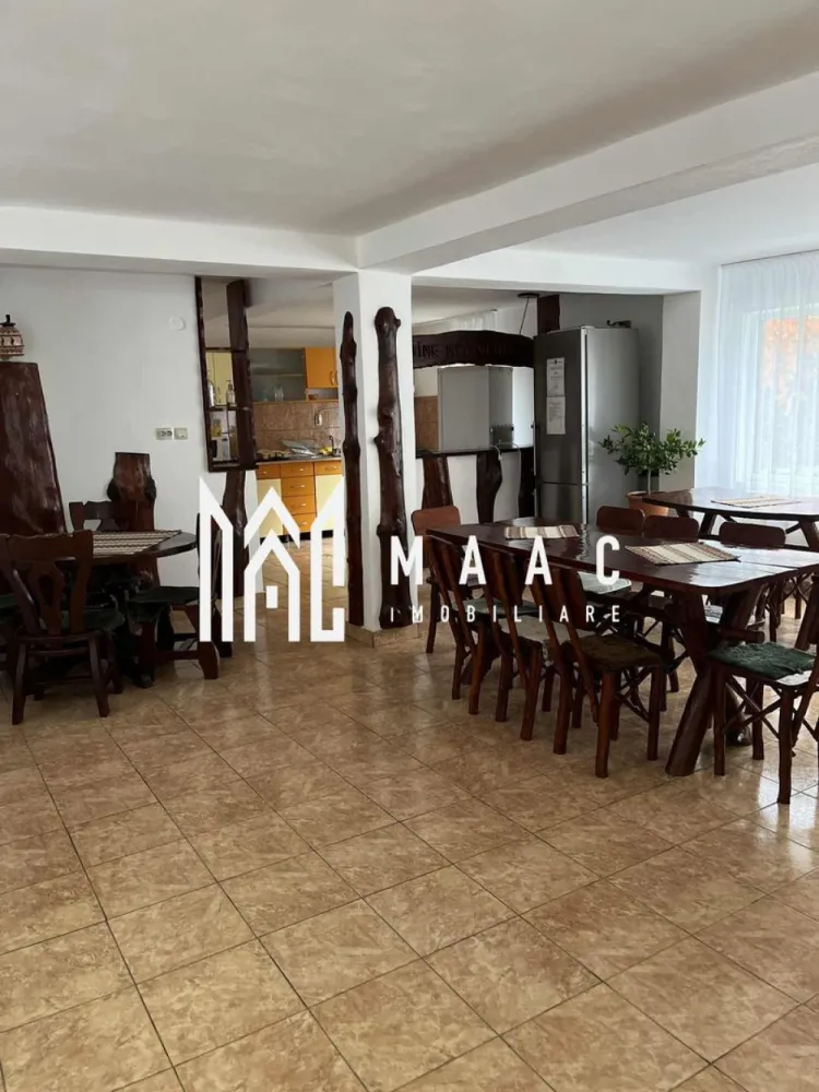 Pensiune I Poalele Munților Făgăraș I Cârțișoara, Sibiu - MAAC Imobiliare vă propune spre achiziție o afacere la cheie, situată într-una dintre cele mai turistice zone din România, la poarta de acces către Transfăgărășan. Proprietatea este cunoscută sub numele de "Complex Cazare Bâlea Transfăgărășan" și se vinde împreună cu întreaga structură a firmei (activitate continuă din 2016).

Detalii Afacere și Proprietate
Capacitate: 17 unități de cazare (în cele 2 corpuri principale), fiecare cu baie proprie.
Anexă suplimentară: 2 unități de cazare cu baie proprie (versatile: pot fi destinate turiștilor sau personalului).
Facilități: Sală de mese, bucătărie comună complet utilată, 2 terase la parter și 2 terase la etaj, zonă de grătar.
Teren: 1000 mp cu parcare privată inclusă.
Acces: Dublu (din DN7C și drum secundar), facilitând fluxul logistic și accesul turiștilor.
Stadiu: Renovare parțială realizată în 2023.
Eficiență și Dotări
Sistem termic: 2 centrale termice performante (lemne/peleți) și 2 camere tehnice aferente.
Operațional: Se vinde complet mobilată și utilată, permițând preluarea activității fără întrerupere.
Prezență online: Istoric solid pe platformele de rezervări (Booking) și vizibilitate pe social media (Instagram: @balea_transfagarasan ).
De ce să investiți în acest complex?
Afacere la cheie: Istoric de profitabilitate și activitate neîntreruptă din 2016.
Locație strategică: Poziționarea pe DN7C (Transfăgărășan) garantează un flux constant de turiști pe tot parcursul sezonului).
Flexibilitate: Infrastructura permite atât gestionarea ca pensiune turistică, cât și adaptarea pentru grupuri organizate sau team-building-uri.
Investiție sigură: Proprietatea este complet operațională, fiind gata de a genera venituri din prima zi de la preluare.
Informații Suplimentare
Dacă sunteți în căutarea unei investiții mature, cu o reputație consolidată în zona montană a județului Sibiu, această pensiune reprezintă opțiunea ideală.
Vă invităm să ne contactați pentru a discuta detaliile financiare, analiza indicatorilor de performanță (ROI, grad de ocupare) și pentru a programa o vizionare la locație. MAAC Imobiliare – Partenerul dumneavoastră în investiții imobiliare de succes.
Pentru mai multe detalii precizati telefonic ca ati vazut anuntul cu ID CP2965008