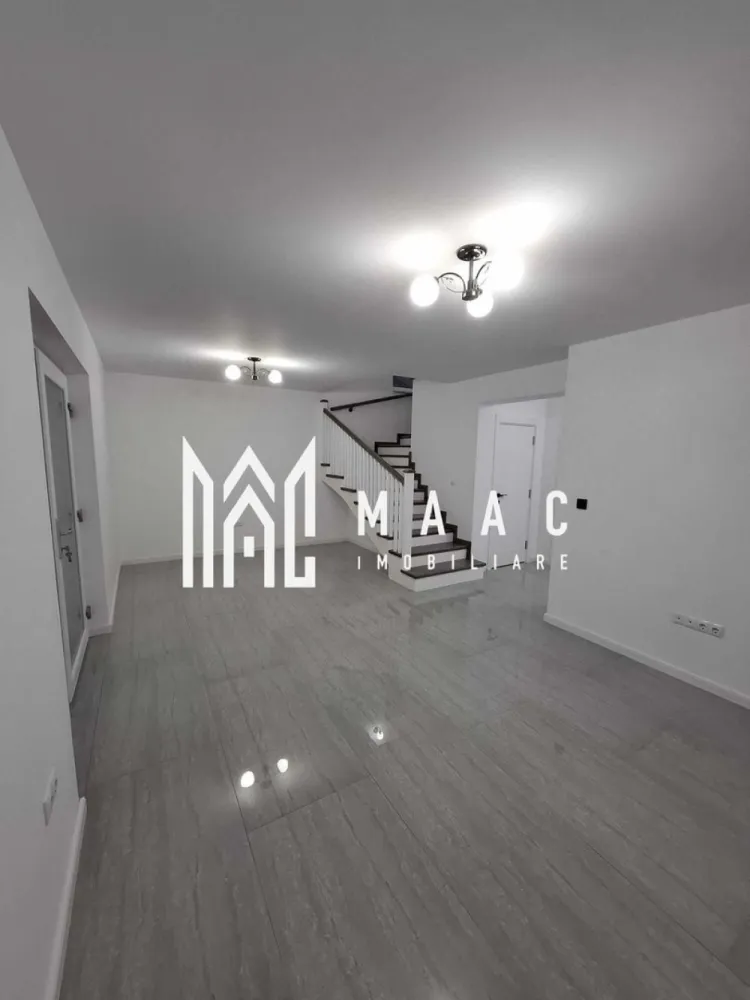 Casă 4 Camere | Prima Închiriere | Cisnădie - MAAC Imobiliare vă propune spre închiriere o casă, construită în anul 2025, situată în Cisnădie, într-o zonă bine poziționată, cu acces rapid către Sibiu, autostradă și principalele centre comerciale din zonă. Compartimentare • living / sufragerie spațioasă • 3 dormitoare • bucătărie separată • cameră tehnică • 3 băi • pod pentru depozitare Casa dispune de curte pavată de aproximativ 100 mp, oferind spațiu pentru relaxare sau parcare. Dotări și avantaje • încălzire în pardoseală atât la parter, cât și la mansardă • centrală termică pe gaz • băi complet mobilate • bucătărie complet mobilată și utilată • acces rapid către magazinele mari din Cisnădie și Sibiu • legătură rapidă cu autostrada Proprietatea oferă confort modern și eficiență energetică, fiind pregătită pentru mutare imediată. Pentru mai multe detalii sau pentru programarea unei vizionări, vă rugăm să ne contactați și să menționați ID-ul proprietății: CP2966831.
