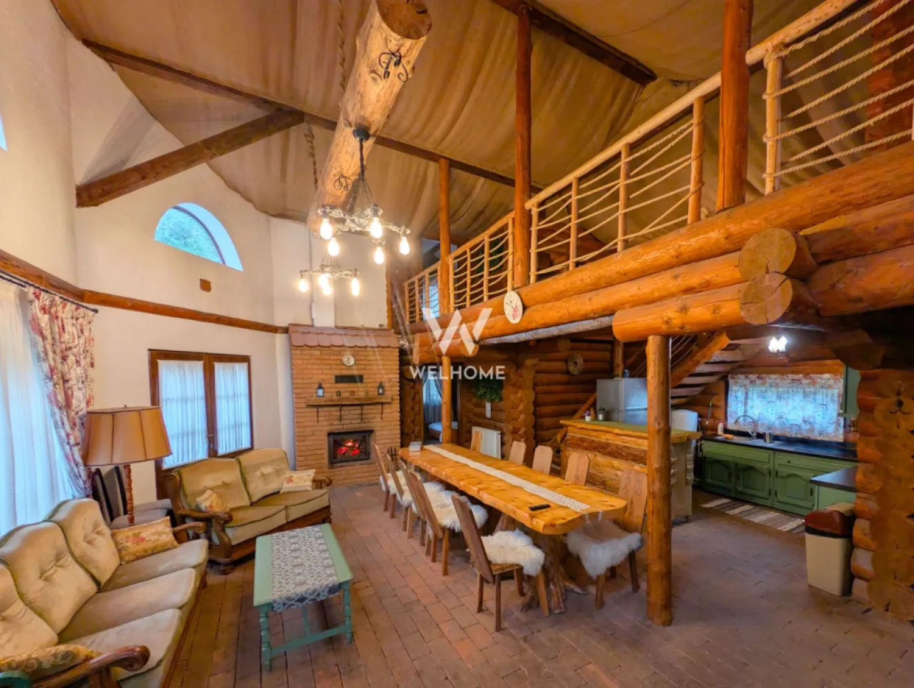 Cabana / Casa de vacanta pe Transfagarasan - Sibiu - Cabana "Rustic Balea"
Această proprietate este o casă de vacanță tip cabană construită predominant din lemn masiv rotund, oferind un refugiu montan ideal pentru grupuri mari. Cabana are o capacitate optimă de cazare de opt persoane, fiind dotată cu patru dormitoare matrimoniale. Un avantaj major pentru confortul oaspeților este faptul că fiecare dormitor beneficiază de baie proprie, modern utilată cu cabină de duș.

Spațiul de zi este extrem de generos, incluzând un living spațios cu tavan înalt, unde domină bârnele de lemn. Aici se găsesc o zonă de relaxare cu canapele amplasată lângă un șemineu tradițional din cărămidă și o masă lungă, din lemn masiv, pentru servit masa. Bucătăria interioară este complet utilată, integrată armonios în living, remarcându-se prin mobilierul vopsit în verde salvie.

În ceea ce privește materialele, cabana utilizează bârne groase, rotunde, din lemn masiv pentru structura principală și pereții interiori, conferind o estetică autentică de log cabin și o izolare excelentă. Pardoseala combină plăcut dușumeaua de lemn din dormitoare cu cărămida sau piatra arsă din living.

Pentru relaxare, cabana oferă facilități de wellness de lux: pe terasa exterioară, cu vedere directă la râu, se află un ciubăr (hot tub) din lemn. Lângă ciubăr, o saună privată interioară completează zona SPA. În exterior, există un foișor acoperit cu masă și bănci rustice, dotat cu o zonă de grătar din cărămidă.

Cadrul natural este de vis, proprietatea fiind situată pe malul unui râu de munte, la poalele muntilor Fagaras. Datorită poziționării sale strategice, cabana servește ca punct de bază ideal pentru explorarea zonei Transfăgărășanului (DN7C).

Cabana/casa de vacanta este listata pe site-urile cu profil turistic fiind foarte cautata si apreciata.

Pret: 299.000 euro.
Comision cumparator 2% + TVA.