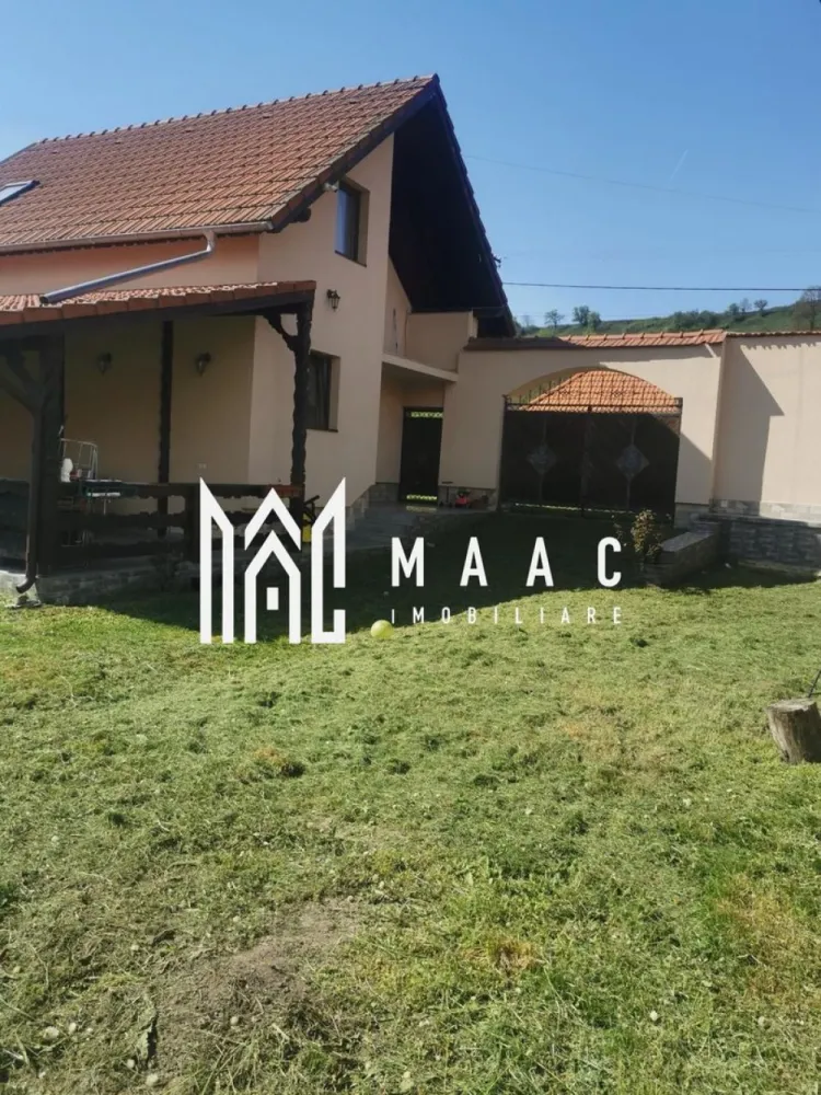 Casă 3 camere | Colun, Sibiu | 94 mp utili, teren 1250 mp - Casă individuală cu 3 camere de vânzare în Colun, județul Sibiu, finalizată în 2021, cu 94 mp utili, teren de 1250 mp și spații exterioare utile pentru locuire și timp petrecut în aer liber.

Detalii proprietate:
• Casă individuală, finalizată în 2021, cu structură din cărămidă și acoperiș din țiglă
• Suprafață utilă: 94 mp
• Teren: 1250 mp
• Compartimentare pe parter și mansardă: bucătărie cu living open space, cameră tehnică, baie cu vană și geam pentru aerisire, hol și casa scării la parter; 2 dormitoare, balcon și acces spre pod la mansardă
• 1 baie, 2 bucătării, 1 balcon și 1 terasă
• Finisată modern, se predă parțial mobilată și utilată
• Centrală electrică, calorifere, panouri pentru apă caldă, izolație termică exterioară și parchet triplustratificat
• Utilități: apă din sistemul comunal, fosă pe 2 zone, curent electric inclusiv trifazic
• Garaj de aproximativ 55 mp pentru 3 mașini, anexă pentru depozitare, curte liberă amenajată ca zonă verde, grădină îngrădită și fântână funcțională

Proprietatea este amplasată într-o zonă liniștită din Colun, cu acces facil către Autostrada A13 Sibiu-Brașov. În apropiere se află Munții Făgăraș, Transfăgărășanul, Mănăstirea Cârța, Palatul Brukenthal Avrig, Valea Avrigului, Albota și Castelul de Lut.

Pentru detalii suplimentare și programarea unei vizionări, contactați echipa MAAC Imobiliare și menționați Cod anunț CP2930688.

Conținut optimizat cu AI, aprobat de agent uman.