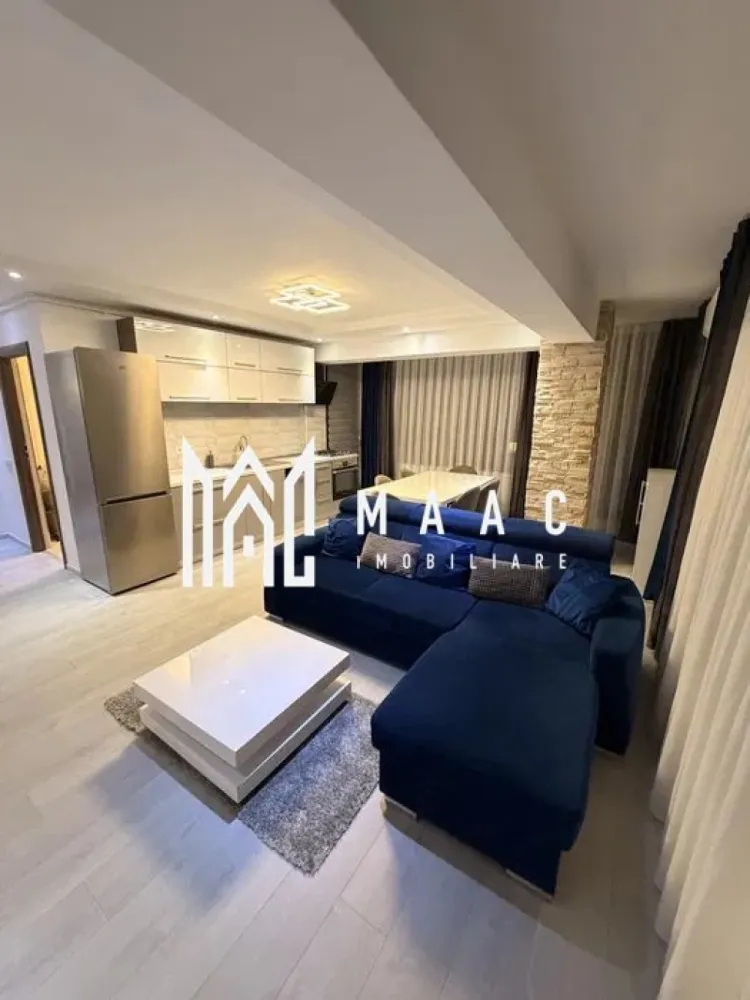 Apartament 2 camere | Șelimbăr – Doamna Stanca | Lângă Kaufland - MAAC Imobiliare vă propune spre închiriere un apartament modern cu 2 camere, situat în Șelimbăr, pe strada Doamna Stanca, într-un complex rezidențial apreciat, aflat în imediata apropiere a Kaufland Șelimbăr și la doar câteva minute de Shopping City Sibiu.

Locuința are o suprafață utilă de 58 mp (exclus balcon) și este compartimentată eficient, oferind un spațiu bine organizat:

living open space cu bucătărie complet echipată
dormitor spațios
baie modernă, dotată cu duș walk-in

Apartamentul este complet mobilat și utilat cu mobilier modern și electrocasnice de calitate, fiind pregătit pentru mutare imediată. Printre dotări se numără:

mașină de spălat rufe cu uscător (LG 2 în 1)
mașină de spălat vase
frigider, aragaz și cuptor
aer condiționat
televizoare în fiecare cameră
finisaje premium (parchet, gresie, faianță tip mozaic)

Imobilul dispune de locuri de parcare în regim „primul venit – primul servit”, însă locul de parcare nu este inclus în prețul chiriei.

Condiții de închiriere:
nu se acceptă animale de companie
disponibilitate imediata.

Pentru mai multe detalii și programarea unei vizionări, vă invităm să ne contactați, menționând ID-ul ofertei:CP2978046
