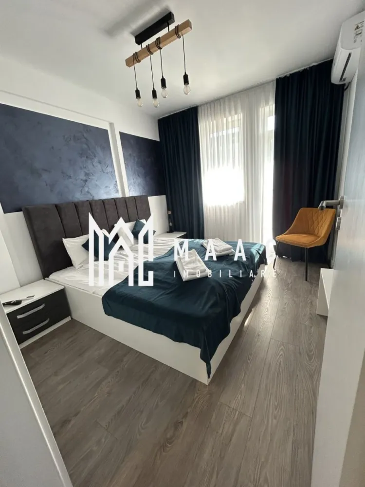 Apartamente 2 Camere | 40Mp | Balcon | Loc de Parcare | Cartierul Henri Coandă - MAAC Imobiliare vă propune spre vânzare un apartament modern cu 2 camere, situat în cartierul Henri Coandă din Sibiu, într-o zonă rezidențială aflată în plină dezvoltare, apreciată pentru liniște, acces facil către oraș și comunitatea rezidențială în continuă formare. Proprietatea reprezintă o alegere potrivită atât pentru locuință personală, cât și pentru investiție imobiliară, datorită poziționării într-un cartier modern și a nivelului ridicat de amenajare.

Apartamentul este amenajat la standarde premium și se vinde complet mobilat și utilat, fiind pregătit pentru mutare imediată sau pentru introducerea rapidă în circuitul de închiriere. Spațiul interior este gândit pentru confort și funcționalitate, cu finisaje moderne, mobilier de calitate superioară și un ambient elegant care oferă un spațiu luminos și primitor.

Dotări și beneficii:
-încălzire în pardoseală
-aer condiționat
-bucătărie complet utilată (plită electrică, frigider și electrocasnice)
-televizoare în fiecare cameră
-mobilier modern de calitate superioară
-loc de parcare inclus

Interiorul apartamentului este amenajat într-un stil modern și elegant, cu atenție la detalii și materiale de calitate, oferind un nivel ridicat de confort pentru viitorii proprietari. Compartimentarea și dotările îl fac potrivit atât pentru utilizare imediată, cât și pentru exploatarea eficientă ca investiție.

Proprietatea este potrivită pentru:
-închiriere pe termen lung
-regim hotelier
-locuință personală

Datorită poziției în cartierul Henri Coandă, una dintre zonele rezidențiale aflate în dezvoltare din Sibiu, apartamentul reprezintă o oportunitate atractivă pentru cumpărătorii care caută o locuință modernă sau o investiție sigură pe piața imobiliară locală.

Bonus: primele apartamente vândute vor beneficia de spațiu de depozitare la subsol, ideal pentru depozitarea obiectelor personale sau sezoniere.

Proprietățile bine amenajate din această zonă se vând rapid, motiv pentru care recomandăm programarea unei vizionări din timp pentru a descoperi avantajele acestei proprietăți.

Pentru mai multe informații și programări la vizionare, vă rugăm să ne contactați telefonic și să menționați CP2955537.