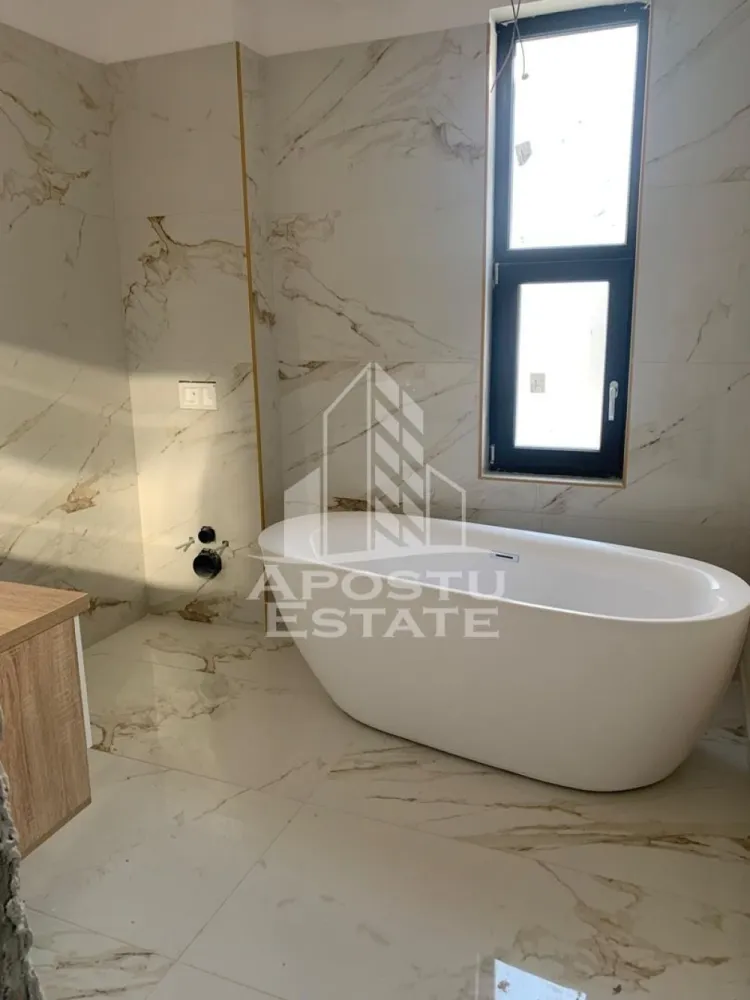 Duplex modern de vanzare in Dumbravita cinci camere - Apostu Estate va propune spre vanzare un duplex modern situat in Dumbravita, una dintre cele mai dinamice si cautate zone rezidentiale din proximitatea Timisoarei, ideala pentru familie sau investitie.

Imobilul are o suprafata utila de aproximativ 180 mp si este amplasat pe un teren de 330 mp, oferind un spatiu bine echilibrat intre interior si exterior.

Compartimentarea este practica si eficienta: 5 camere spatioase, 3 bai si 1 garaj, gandite pentru confortul unei familii moderne.

Constructia este finalizata in anul 2022, realizata din caramida, cu finisaje moderne si standarde actuale de locuire.

Dotari si beneficii:
 • Centrala proprie
 • Incalzire in pardoseala
 • Aer conditionat
 • Dressing
 • Bucatarie mobilata
 • Toate utilitatile: apa, gaz, curent, canalizare, internet, CATV
 • Strazi asfaltate si iluminat stradal

Avantaje zona:
 • Dumbravita – zona rezidentiala moderna, aerisita si in continua dezvoltare
 • Acces rapid catre Timisoara, zona de nord
 • Aproape de Padurea Verde – ideal pentru relaxare si activitati in aer liber
 • In proximitate: scoli, gradinite si centre educationale
 • Supermarketuri, magazine si farmacii in apropiere
 • Restaurante, cafenele si servicii diverse
 • Acces facil la mijloace de transport

Proprietatea se remarca prin locatie, constructie recenta si compartimentare eficienta, fiind o alegere potrivita atat pentru locuinta proprie, cat si pentru investitie.