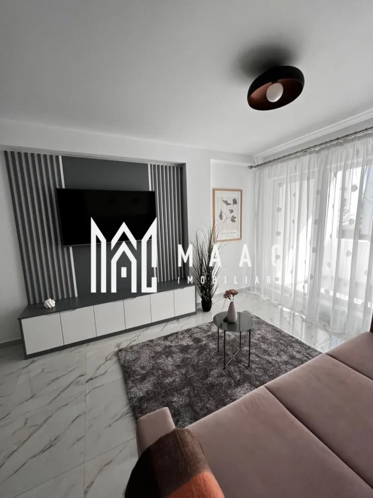 Apartament 3 camere | Terasă 12 MP | Parcare | Turnisor - MAAC Imobiliare vă propune spre închiriere un apartament modern cu 3 camere, situat într-un bloc nou din Cartierul Kogălniceanu, la doar câțiva pași de centrul orașului — o locație excelentă pentru cei care își doresc confort, eleganță și acces rapid către toate punctele de interes.

Cu o suprafață utilă de 71 mp, la care se adaugă o terasă generoasă de 12 mp, proprietatea impresionează prin designul contemporan, compartimentarea inteligentă și finisajele premium.

Compartimentare:

living spațios open-space cu bucătărie modernă și insulă
2 dormitoare luminoase
1 baie elegant amenajată
terasă spațioasă de 12 mp, ideală pentru relaxare

Dotări și beneficii:

încălzire în pardoseală
aer condiționat
electrocasnice moderne de ultimă generație
frigider dedicat pentru vinuri
finisaje premium
mobilier premium realizat la comandă
se închiriază complet mobilat și utilat
loc de parcare inclus
bloc nou

Apartamentul este ideal pentru cei care își doresc să locuiască într-una dintre cele mai apreciate zone rezidențiale, aproape de centru, restaurante, cafenele, școli și zone de promenadă.

Dacă îți dorești un apartament „la cheie”, amenajat cu bun gust și atenție la fiecare detaliu, această proprietate este alegerea perfectă.

Pentru mai multe detalii și programarea unei vizionări, vă rugăm să ne contactați telefonic și să menționați CP3036052.